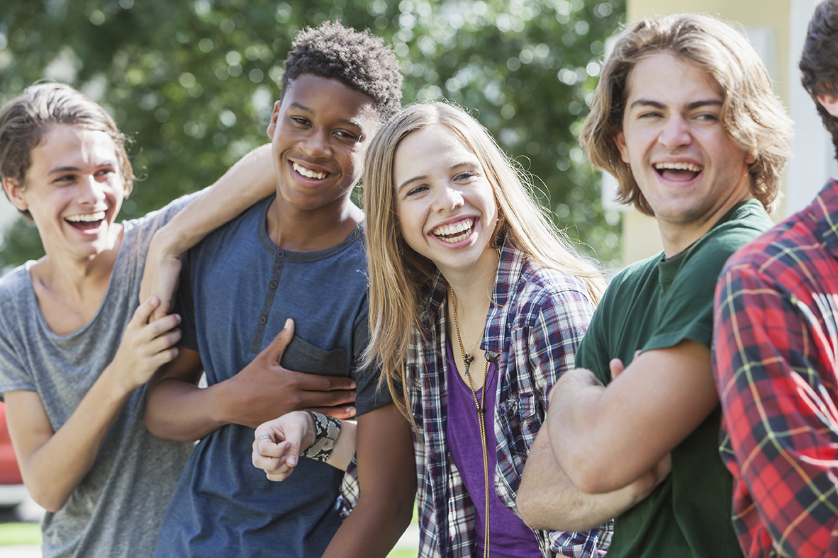 Multiracial group of teenagers handing out outdoors